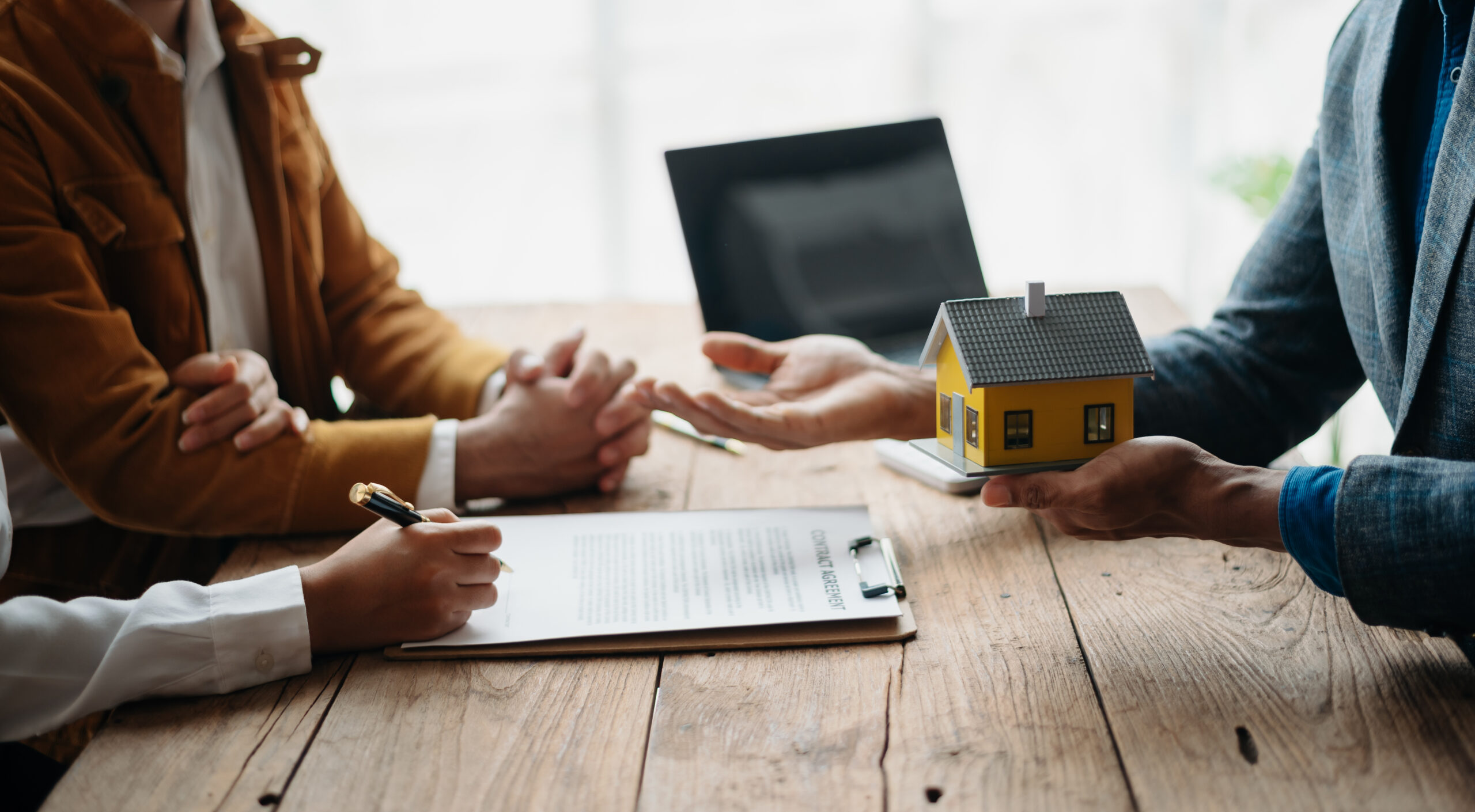 A family couple sign a lease meeting with a realtor or homeowner